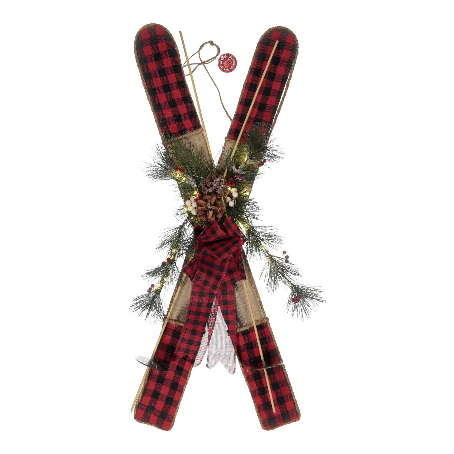 Decorative skis with plaid pattern and greenery on a white background