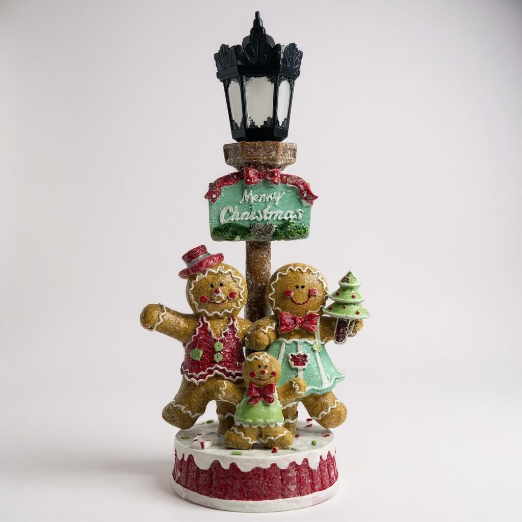 Decorative Christmas figurine with gingerbread people and a street lamp on a white background