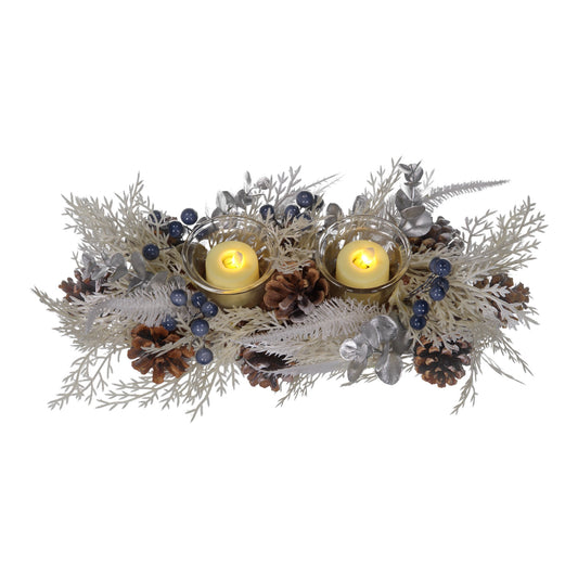 Decorative arrangement with candles, pinecones, and branches on a white background