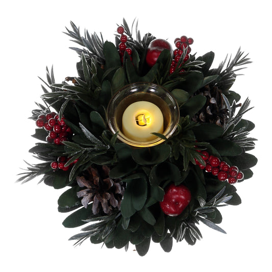 Decorative wreath with a candle surrounded by greenery and red berries on a white background
