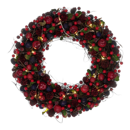 Decorative wreath with red berries and lights on a white background