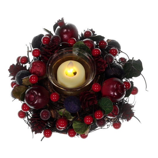 Decorative wreath with berries and a candle on a white background