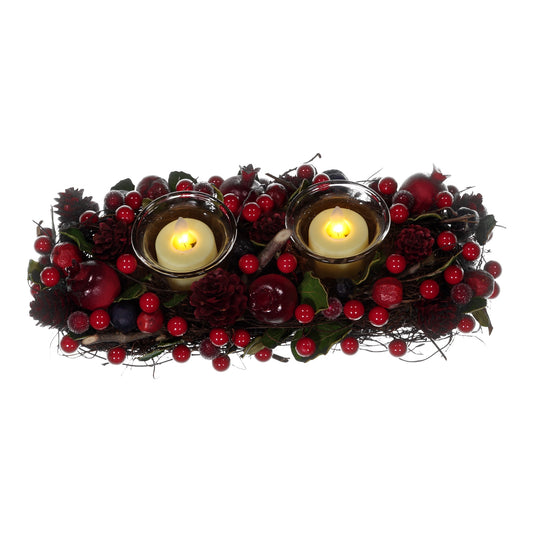 Decorative wreath with candles and red berries on a white background