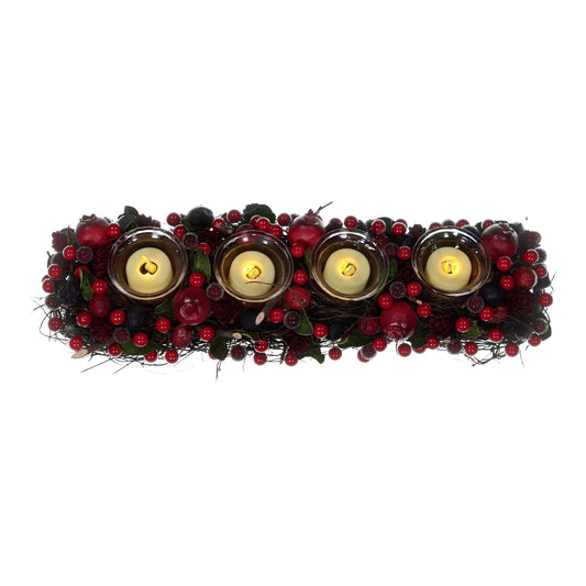Decorative wreath with four lit candles surrounded by red berries on a white background