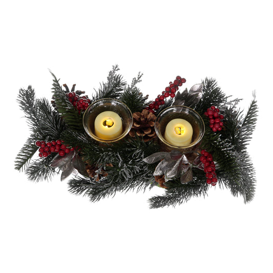 Decorative wreath with candles, pine cones, and red berries on a white background