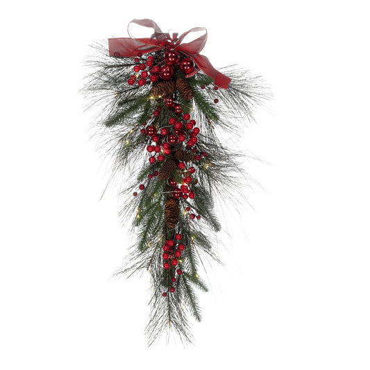 Decorative Christmas swag with red berries and a bow on a white background