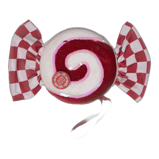 Red and white candy-shaped plush toy with checkered bow on a white background