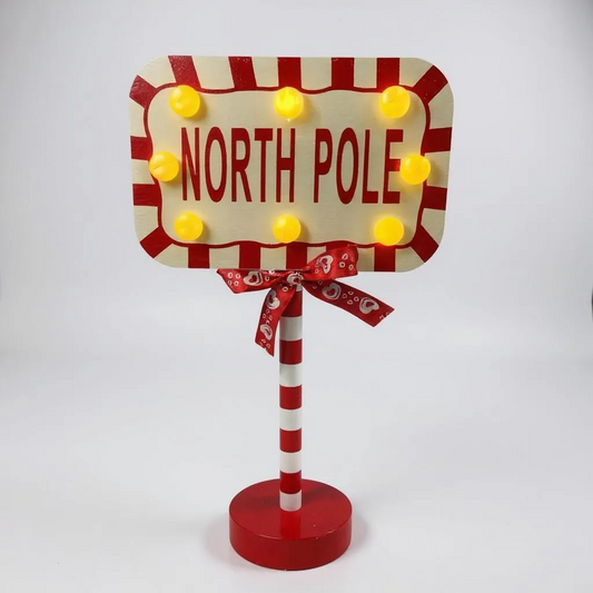 Decorative sign with 'North Pole' text on a white background