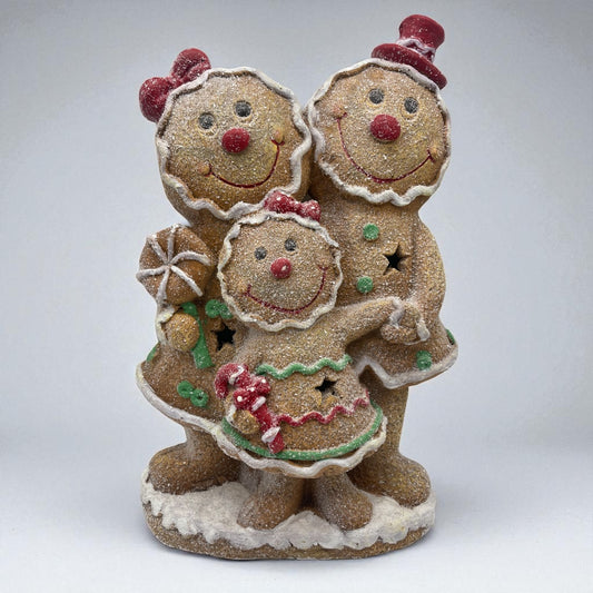 Decorative gingerbread family figurine on a white background